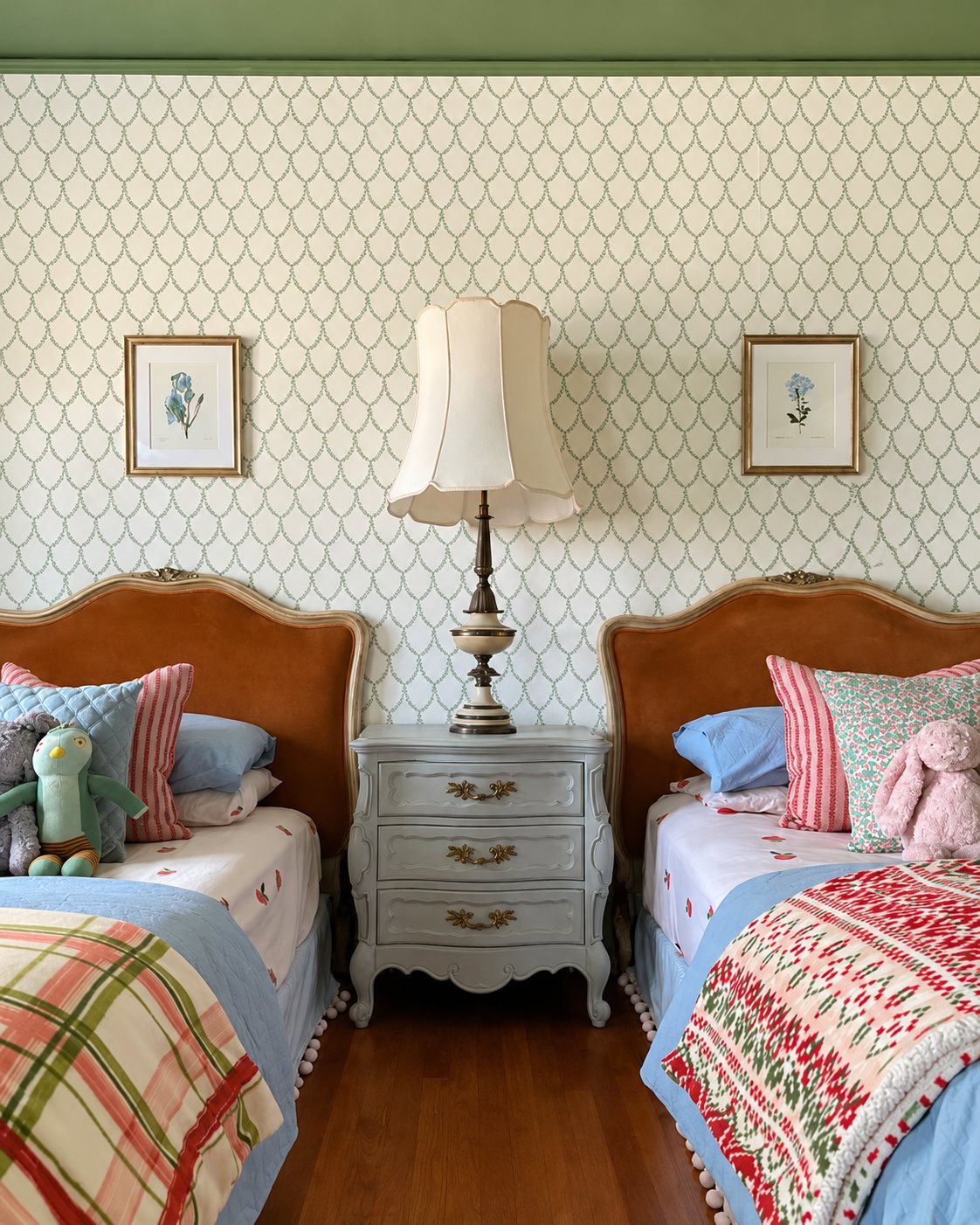 Twin bedroom with trellis wallpaper, vintage wood beds and botanical prints
